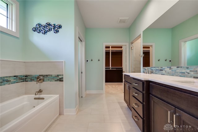 1461 Abbey Park Pl, Beavercreek Twp, OH 45385 - bathroom with a garden tub, a spacious closet, double vanity, tasteful backsplash, and tile patterned floors