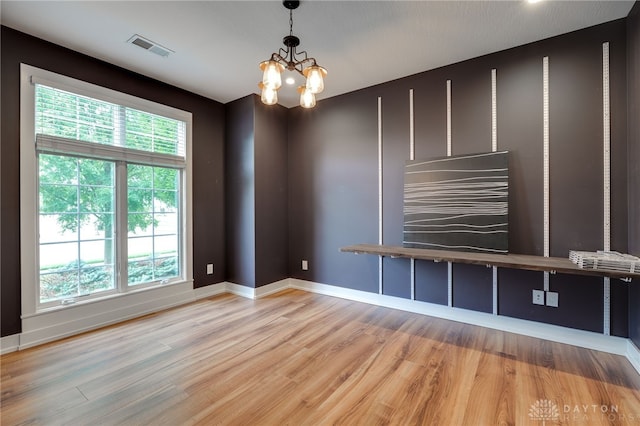 1461 Abbey Park Pl, Beavercreek Twp, OH 45385 - unfurnished living room with wood finished floors and a chandelier
