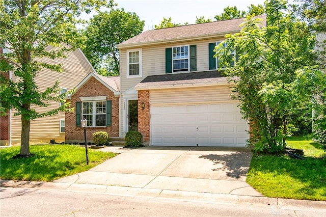 3583 King Edward Way, Beavercreek, OH 45431 - traditional-style home featuring driveway, an attached garage, a front yard, and brick siding