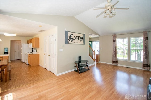 3583 King Edward Way, Beavercreek, OH 45431 - living room with light wood finished floors, a ceiling fan, vaulted ceiling, and stairs