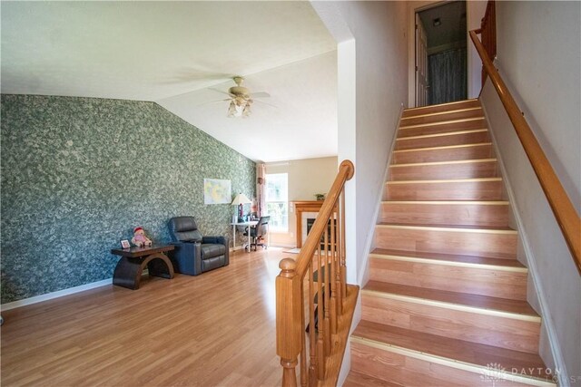 3583 King Edward Way, Beavercreek, OH 45431 - stairway with wallpapered walls, vaulted ceiling, wood finished floors, and ceiling fan