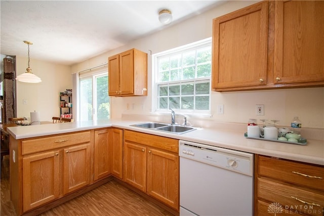 3583 King Edward Way, Beavercreek, OH 45431 - kitchen with white dishwasher, a peninsula, light wood-style flooring, light countertops, and hanging light fixtures
