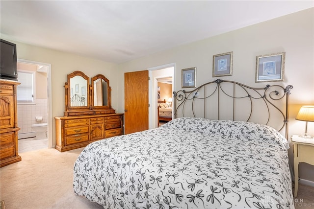 5136 Oleva Dr, Sugarcreek Twp, OH 45440 - bedroom with light carpet, baseboard heating, tile walls, and connected bathroom