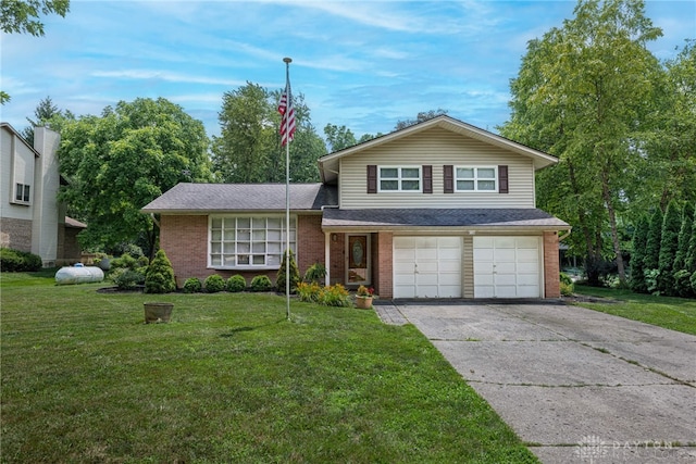 5136 Oleva Dr, Sugarcreek Twp, OH 45440 - split level home featuring an attached garage, brick siding, concrete driveway, a front yard, and roof with shingles