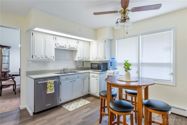 5136 Oleva Dr, Sugarcreek Twp, OH 45440 - kitchen featuring stainless steel dishwasher, black microwave, light wood-style flooring, a ceiling fan, and tasteful backsplash