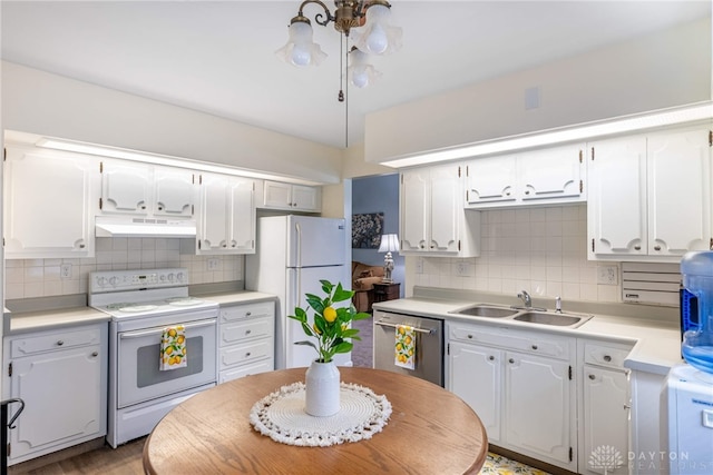 5136 Oleva Dr, Sugarcreek Twp, OH 45440 - kitchen with white appliances, under cabinet range hood, decorative backsplash, and white cabinets