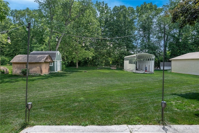 5136 Oleva Dr, Sugarcreek Twp, OH 45440 - view of grassy yard featuring a shed and a detached carport