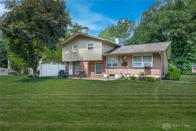 5136 Oleva Dr, Sugarcreek Twp, OH 45440 - back of property featuring brick siding, a chimney, cooling unit, a patio, and a shingled roof
