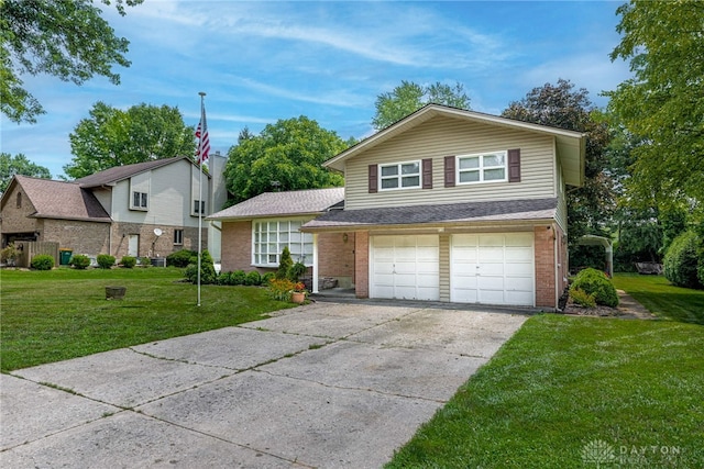 5136 Oleva Dr, Sugarcreek Twp, OH 45440 - tri-level home with a garage, brick siding, concrete driveway, and a front lawn