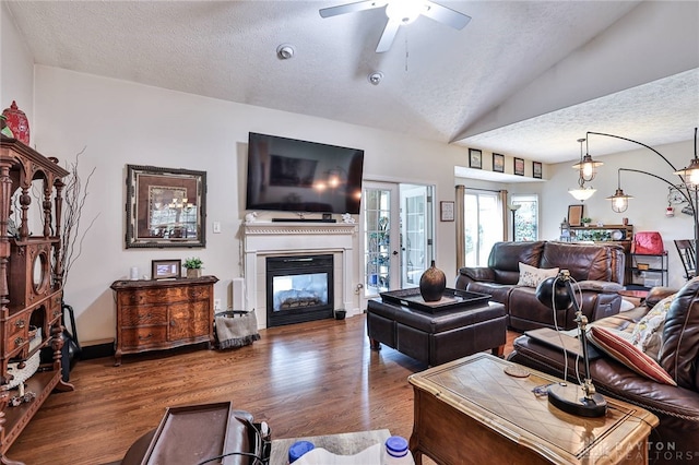 595 Heatherwoode Cir, Springboro, OH 45066 - living area featuring a textured ceiling, a ceiling fan, wood finished floors, a glass covered fireplace, and lofted ceiling