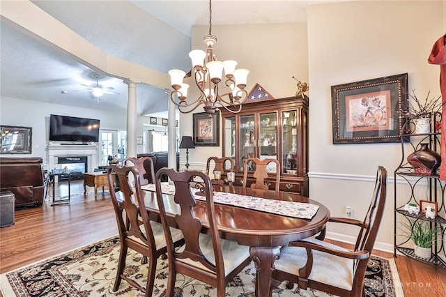 595 Heatherwoode Cir, Springboro, OH 45066 - dining room with wood finished floors, a glass covered fireplace, ceiling fan, a chandelier, and ornate columns