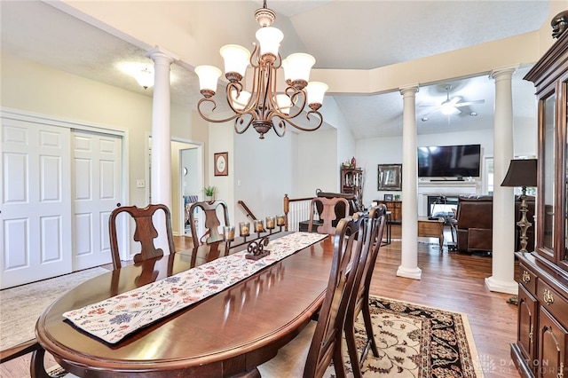 595 Heatherwoode Cir, Springboro, OH 45066 - dining room with decorative columns, wood finished floors, a chandelier, lofted ceiling, and a fireplace
