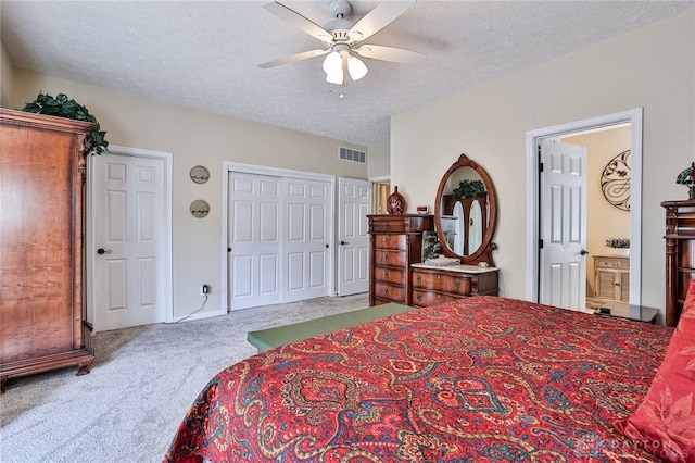 595 Heatherwoode Cir, Springboro, OH 45066 - carpeted bedroom with a textured ceiling, a ceiling fan, and ensuite bath