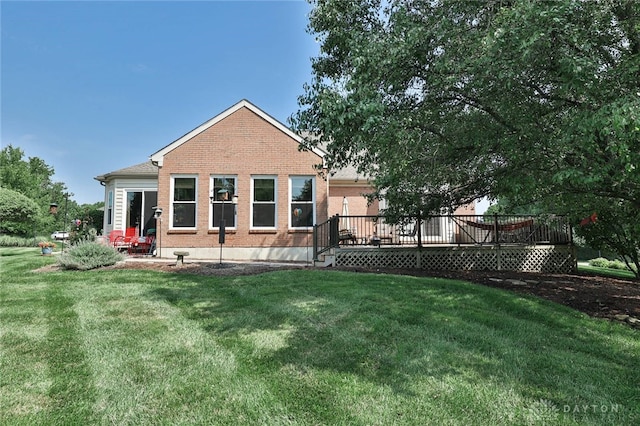 595 Heatherwoode Cir, Springboro, OH 45066 - rear view of property with a lawn, a deck, and brick siding
