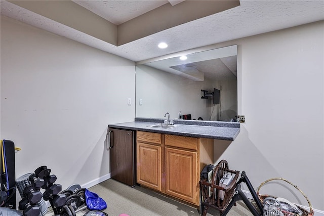 595 Heatherwoode Cir, Springboro, OH 45066 - indoor wet bar featuring light colored carpet, refrigerator, recessed lighting, and a textured ceiling