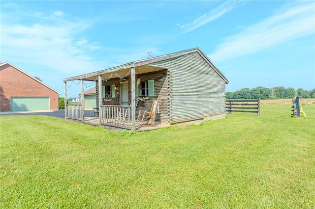 1061 Mcpherson Rd, Xenia, OH 45385 - rear view of property featuring a garage, log exterior, and asphalt driveway