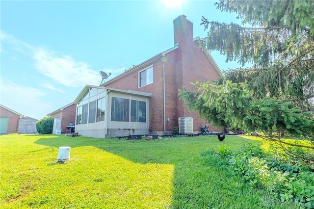 1061 Mcpherson Rd, Xenia, OH 45385 - view of property exterior featuring brick siding, a chimney, a lawn, and a sunroom