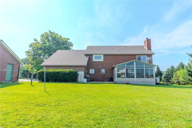 1061 Mcpherson Rd, Xenia, OH 45385 - rear view of house with a yard, a chimney, a sunroom, and brick siding