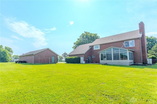 1061 Mcpherson Rd, Xenia, OH 45385 - rear view of property featuring a lawn, a chimney, and brick siding