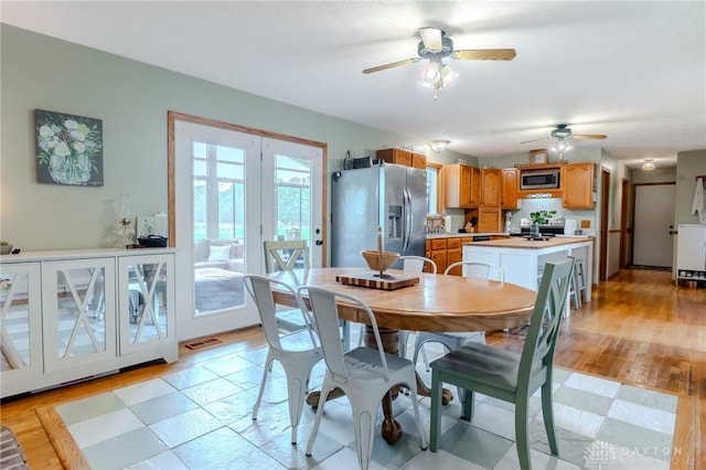 1061 Mcpherson Rd, Xenia, OH 45385 - dining space with ceiling fan, french doors, and light wood finished floors