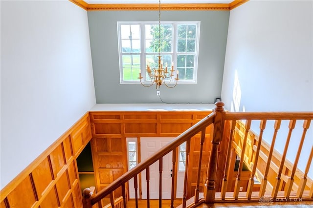 1061 Mcpherson Rd, Xenia, OH 45385 - stairs with a chandelier, ornamental molding, a towering ceiling, and a decorative wall