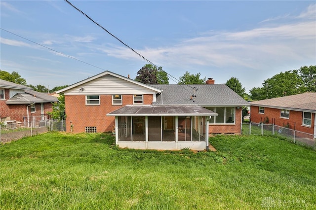 1095 Susan Dr, Hamilton, OH 45013 - rear view of property with a sunroom, brick siding, a chimney, and a fenced backyard