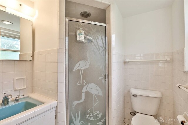 1095 Susan Dr, Hamilton, OH 45013 - bathroom featuring tile walls, a stall shower, vanity, and a wainscoted wall