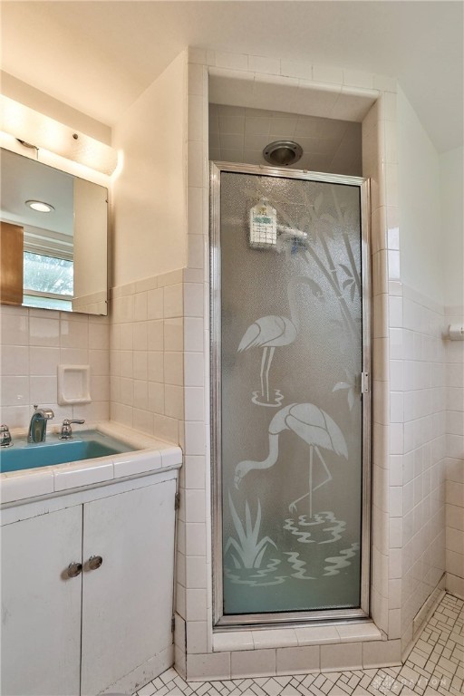 1095 Susan Dr, Hamilton, OH 45013 - full bathroom featuring tile walls, a stall shower, and vanity