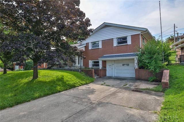 1095 Susan Dr, Hamilton, OH 45013 - view of front of property with brick siding, an attached garage, a front lawn, and driveway