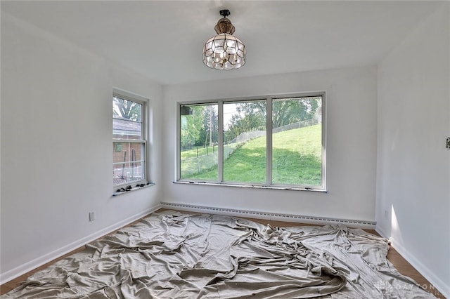 1095 Susan Dr, Hamilton, OH 45013 - unfurnished room with baseboard heating and a chandelier