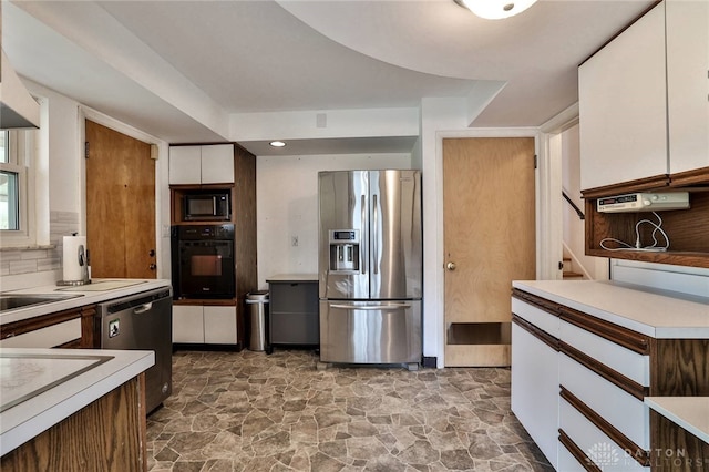 1095 Susan Dr, Hamilton, OH 45013 - kitchen featuring black appliances, white cabinets, light countertops, stone finish flooring, and recessed lighting