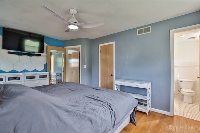 1095 Susan Dr, Hamilton, OH 45013 - bedroom with wood finished floors, ensuite bathroom, and ceiling fan