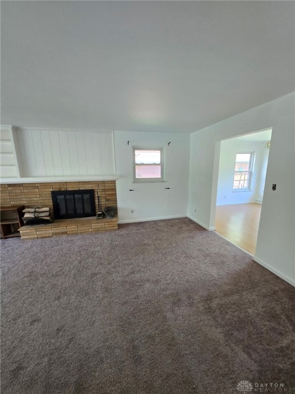 1095 Susan Dr, Hamilton, OH 45013 - unfurnished living room featuring a brick fireplace and carpet floors