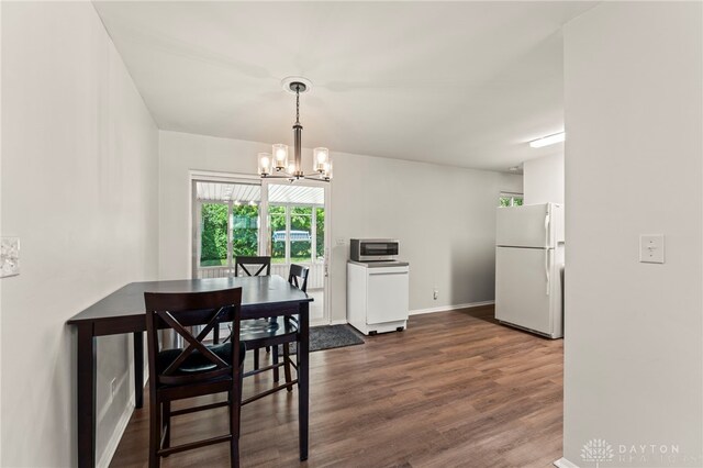 1021 Nutmeg Sq, Troy, OH 45373 - dining space featuring a chandelier and dark wood finished floors