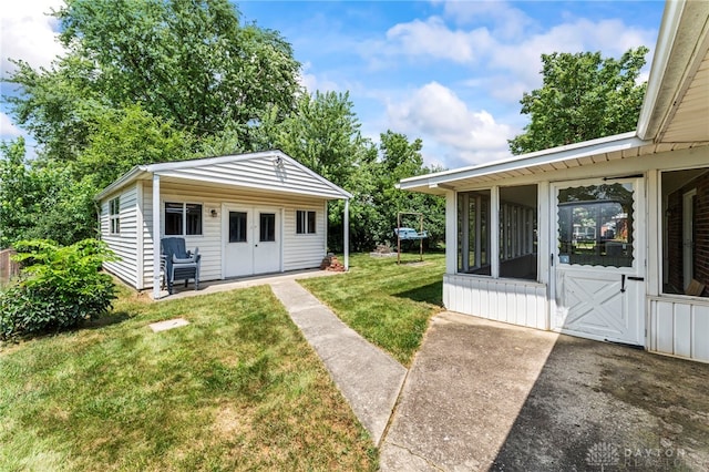 1021 Nutmeg Sq, Troy, OH 45373 - view of grassy yard featuring an outbuilding and a sunroom