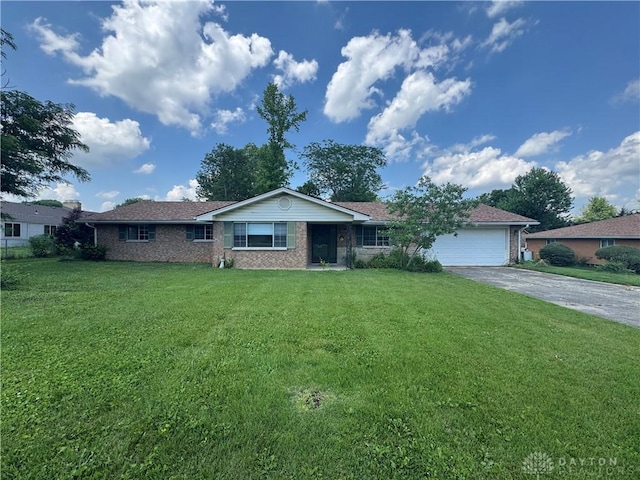2886 Kemp Rd, Beavercreek, OH 45431 - ranch-style home with brick siding, an attached garage, concrete driveway, and a front yard