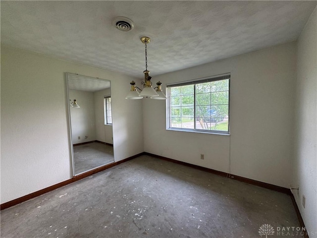 2886 Kemp Rd, Beavercreek, OH 45431 - empty room with a chandelier and a textured ceiling