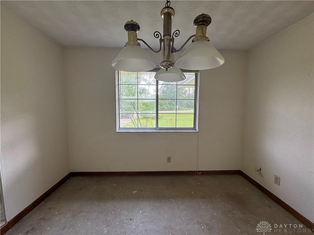 2886 Kemp Rd, Beavercreek, OH 45431 - unfurnished room with baseboards and a chandelier