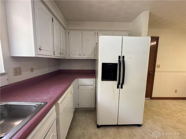 2886 Kemp Rd, Beavercreek, OH 45431 - kitchen with white appliances, dark countertops, light tile patterned flooring, and white cabinetry