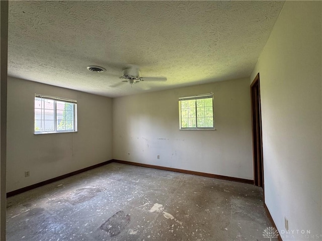 2886 Kemp Rd, Beavercreek, OH 45431 - spare room featuring plenty of natural light, a ceiling fan, and a textured ceiling