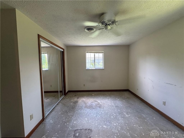 2886 Kemp Rd, Beavercreek, OH 45431 - unfurnished bedroom with a textured ceiling, a closet, and a ceiling fan
