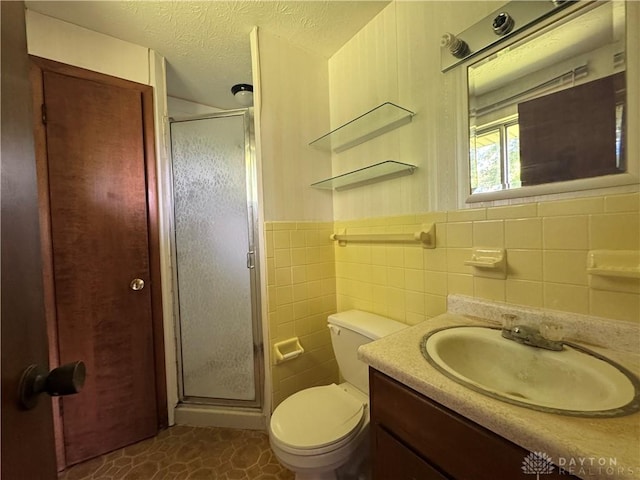 2886 Kemp Rd, Beavercreek, OH 45431 - full bathroom with a stall shower, vanity, a textured ceiling, and tile walls