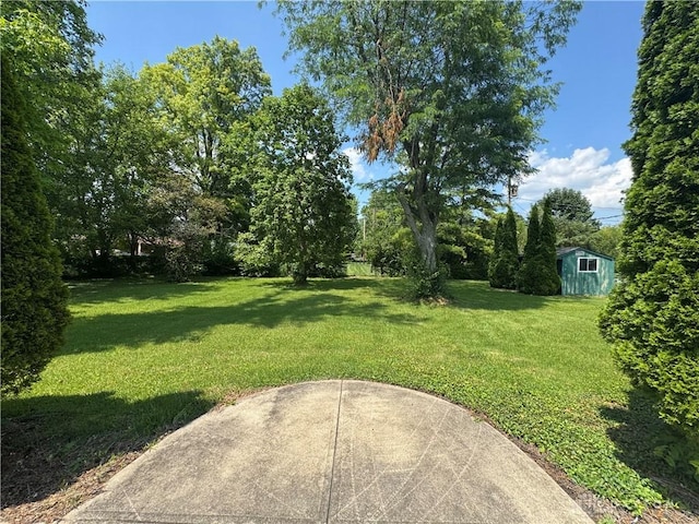 2886 Kemp Rd, Beavercreek, OH 45431 - view of grassy yard featuring a storage unit and a patio