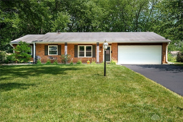 222 Kenderton Trl, Beavercreek, OH 45430 - single story home with asphalt driveway, brick siding, a garage, and a front lawn