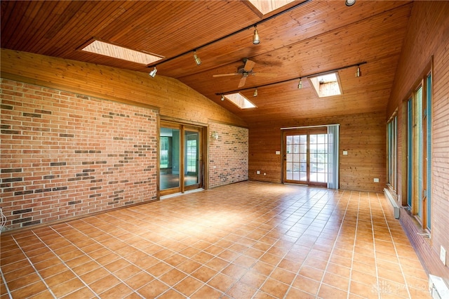 222 Kenderton Trl, Beavercreek, OH 45430 - empty room with track lighting, a skylight, brick wall, wood ceiling, and vaulted ceiling