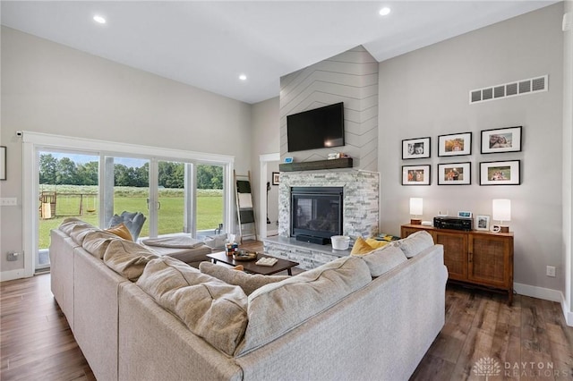 9782 E US Highway 22 And 3, Clarksville, OH 45113 - living area featuring a stone fireplace, dark wood-style floors, recessed lighting, and a towering ceiling