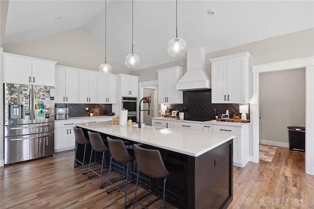 9782 E US Highway 22 And 3, Clarksville, OH 45113 - kitchen featuring stainless steel fridge, custom range hood, backsplash, a kitchen bar, and light countertops