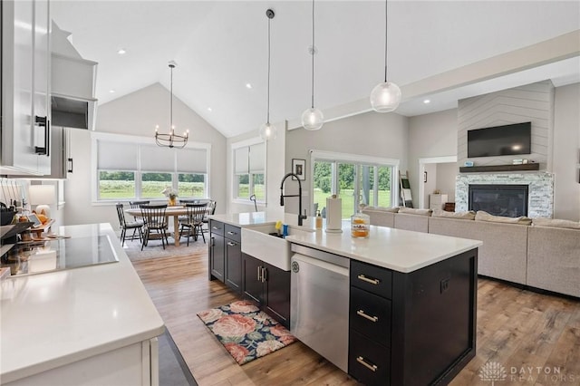 9782 E US Highway 22 And 3, Clarksville, OH 45113 - kitchen with stainless steel dishwasher, high vaulted ceiling, light countertops, healthy amount of natural light, and dark cabinets