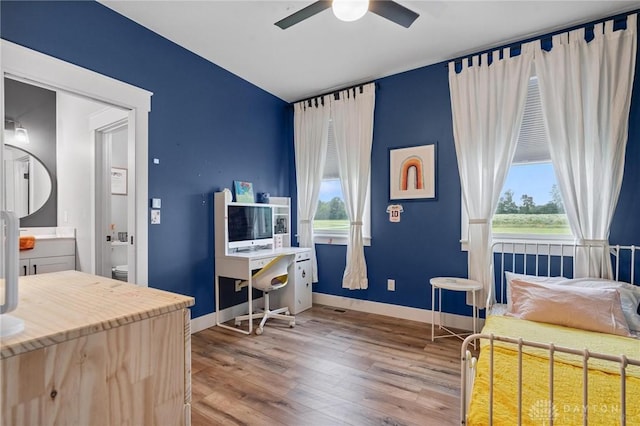 9782 E US Highway 22 And 3, Clarksville, OH 45113 - bedroom featuring wood finished floors, connected bathroom, and a ceiling fan