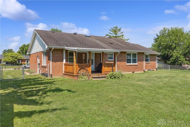 222 Alumni Cir, Wilmington, OH 45177 - back of property featuring covered porch, brick siding, a gate, a fenced backyard, and a shingled roof